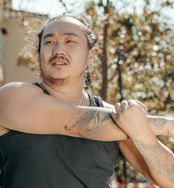 A person stretching outdoors with a sense of freedom and well-being.